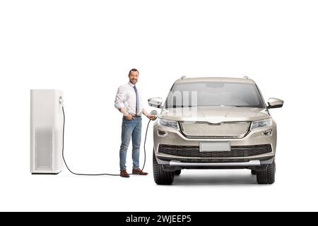 Businessman charging electric vehicle and looking at camera isolated on white background Stock Photo