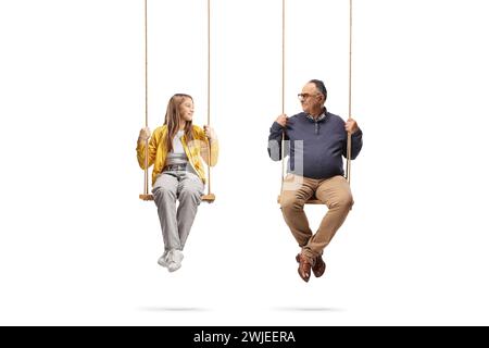 Mature man and a teenage girl sitting on swings and looking at each other isolated on white background Stock Photo