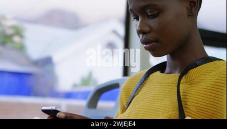 Boy texting with floating message icons Stock Photo