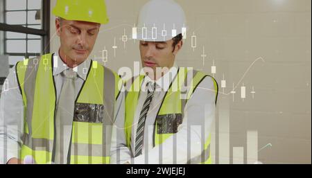 Two male architects discuss plans with graphs Stock Photo