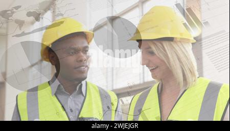 Two architects review building plans with foreground graphs Stock Photo