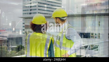 Two architects discuss plans on a rooftop, cityscape and data in view Stock Photo
