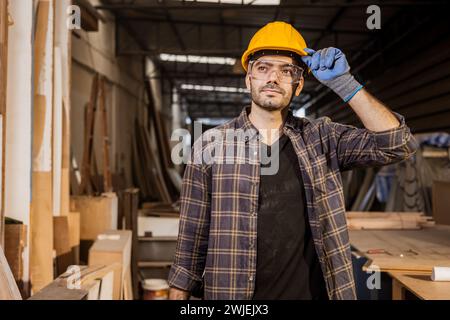 hispanic indian carpenter man standing proud looking high to making furniture in workshop Stock Photo
