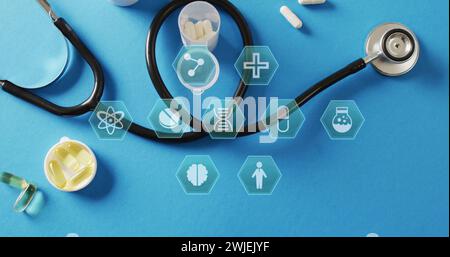 Image of medical icons over pills and stethoscope Stock Photo