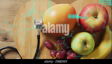 Image of data processing over stethoscope and fruit Stock Photo