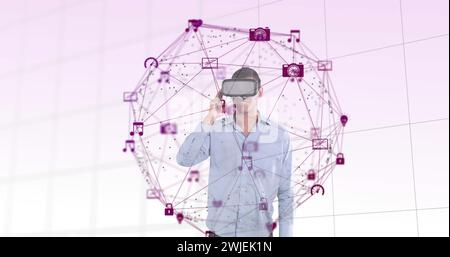 Man in VR headset interacts with a global network interface in a digital concept image. Stock Photo