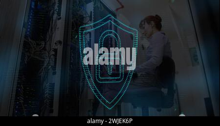 Digital security concept shown with padlock icon on woman's laptop in server room. Stock Photo