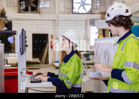 engineer team staff worker working in wooden furniture factory control operate wood cutter machine Stock Photo