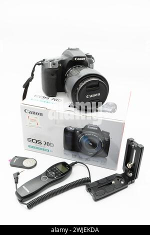 Valencia, Spain - August 8, 2021: Canon camera model 70D DSLR with a zoom lens with its box and accessories such as remote shutter release, intervalom Stock Photo