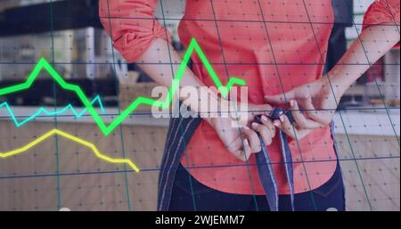 Image of data processing over caucasian female shop assistant tying apron Stock Photo