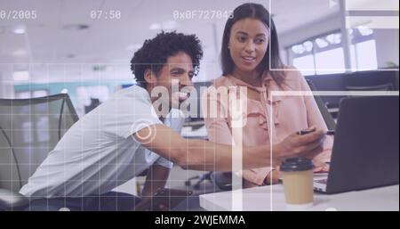 Biracial couple collaborates in a modern office Stock Photo