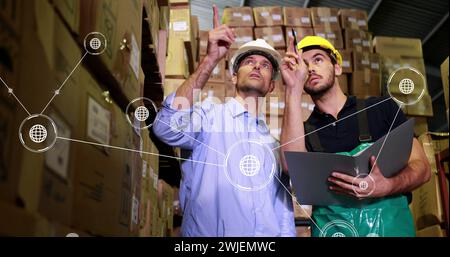 Image of network of conncetions with icons over caucasian male workers in warehouse Stock Photo