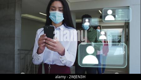 Image of icons and data processing over diverse business people standing in line in face masks Stock Photo
