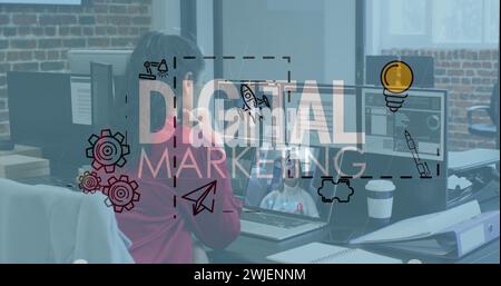 Digital marketing text and icons against woman having a image call on laptop at office Stock Photo