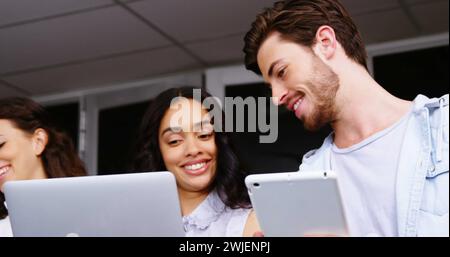 Diverse young professionals engaged in a project at the office Stock Photo
