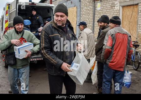 Orikhiv, Ukraine. 13th Feb, 2024. People receive humanitarian aid at a humanitarian aid distribution spot in Orikhiv. Orikhiv is a small town near Zaporizhzhia, which serves as the last pillar of resistance for Ukrainian army soldiers in the south, as Russian armed forces continue to advance to the liberated Robotyne. Home to around 700 people, Orikhiv's citizens risk their lives enduring the daily air bomb and artillery attacks as they struggle to survive. Credit: SOPA Images Limited/Alamy Live News Stock Photo