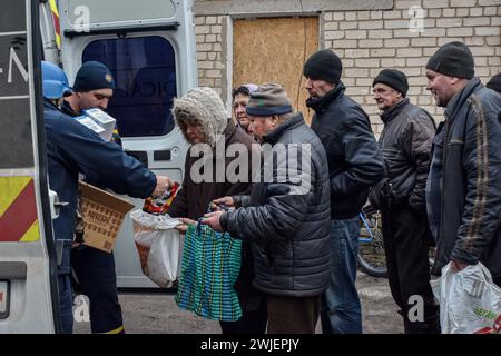 Orikhiv, Ukraine. 13th Feb, 2024. People receive humanitarian aid at a humanitarian aid distribution spot in Orikhiv. Orikhiv is a small town near Zaporizhzhia, which serves as the last pillar of resistance for Ukrainian army soldiers in the south, as Russian armed forces continue to advance to the liberated Robotyne. Home to around 700 people, Orikhiv's citizens risk their lives enduring the daily air bomb and artillery attacks as they struggle to survive. Credit: SOPA Images Limited/Alamy Live News Stock Photo