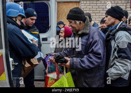 Orikhiv, Ukraine. 13th Feb, 2024. People receive humanitarian aid at a humanitarian aid distribution spot in Orikhiv. Orikhiv is a small town near Zaporizhzhia, which serves as the last pillar of resistance for Ukrainian army soldiers in the south, as Russian armed forces continue to advance to the liberated Robotyne. Home to around 700 people, Orikhiv's citizens risk their lives enduring the daily air bomb and artillery attacks as they struggle to survive. (Photo by Andriy Andriyenko/SOPA Images/Sipa USA) Credit: Sipa USA/Alamy Live News Stock Photo