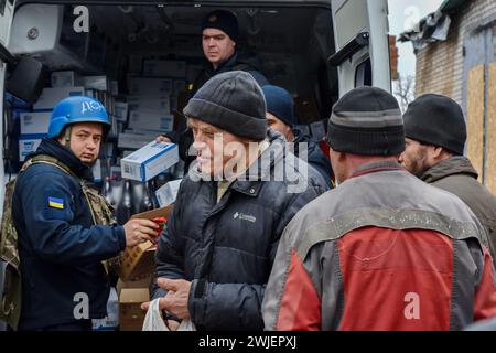 Orikhiv, Ukraine. 13th Feb, 2024. People receive humanitarian aid at a humanitarian aid distribution spot in Orikhiv. Orikhiv is a small town near Zaporizhzhia, which serves as the last pillar of resistance for Ukrainian army soldiers in the south, as Russian armed forces continue to advance to the liberated Robotyne. Home to around 700 people, Orikhiv's citizens risk their lives enduring the daily air bomb and artillery attacks as they struggle to survive. (Photo by Andriy Andriyenko/SOPA Images/Sipa USA) Credit: Sipa USA/Alamy Live News Stock Photo