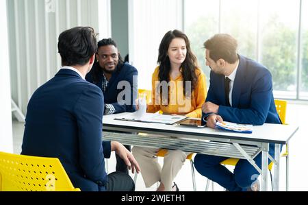 Job interview concept. Diverse hr team doing job interview with a man in business office. Human resources team interviewing a potential job candidate. Stock Photo