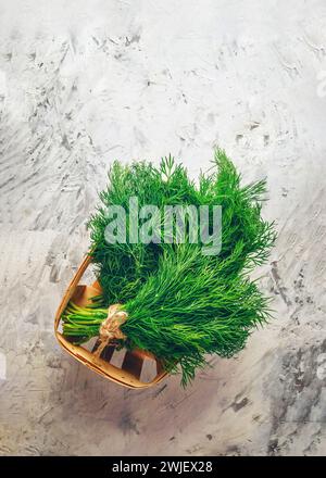A bunch of fresh parsley on a kitchen board. Parsley sprigs top view. Spicy herbs for cooking. bunch of green parsley leafs on wooden surface Stock Photo
