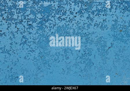 Blue peeling paint on a metal surface. Stock Photo