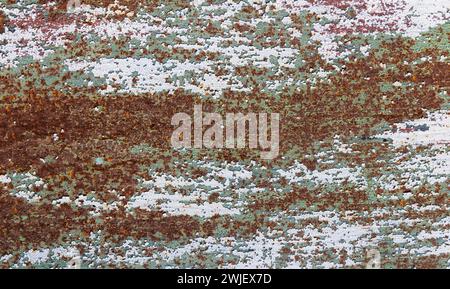 Texture of rusty old metal plate with cracked white and green paint. Stock Photo