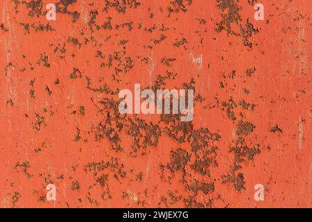 Texture of old rusty metal plate with red cracked paint with scratches. Stock Photo
