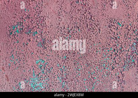 Texture of old pink cracked paint on wall. Damaged paint texture. Stock Photo