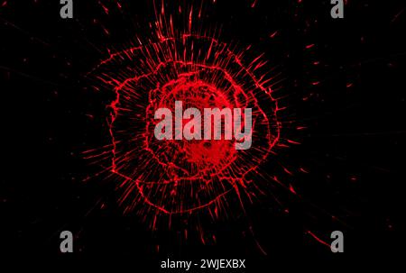 Red crack in broken window on black background. Broken glass texture. Stock Photo