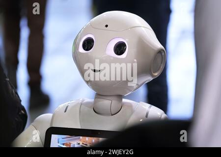 Turin, Italy - February 14, 2024: Pepper, a robotic assistant with an information screen, greets visitors to a stand at the Artificial Intelligence fo Stock Photo