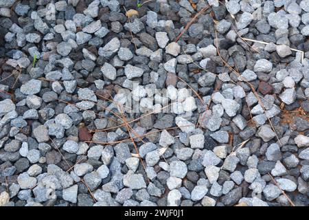 Gray gravel scattered on the ground. Stock Photo