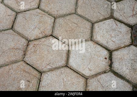 The road is covered with 6-sided paving in gray. Stock Photo