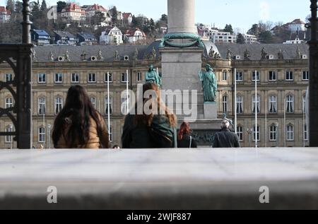 Stuttgart, Germany. 15th Feb, 2024. In the sunshine and mild spring-like temperatures, people sit on a staircase on the castle square. Credit: Bernd Weißbrod/dpa/Alamy Live News Stock Photo