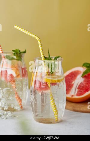 Detox vitaminized water. Summer aesthetic drink with citrus. Lemon, grapefruit, orange, mint. Low alcohol, hard seltzer, zero proof beverages. Stock Photo