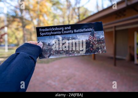 Chancellorsville, Virginia - November 4, 2023: Hand holds a National Parks map and brochure for Fredericksburg and Spotsylvania County battlefields Stock Photo