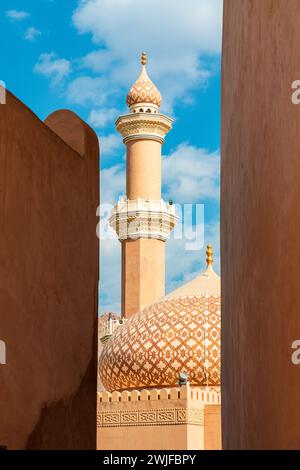 Al Qala'a Mosque in Nizwa, Oman. View on mosque minaret through fort walls Stock Photo