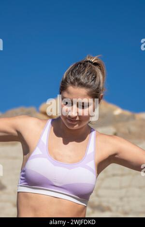 pretty young blonde woman wearing a purple sports bra Stock Photo