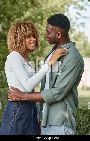 Emotional african couple holding hands and jumping up Stock Photo - Alamy