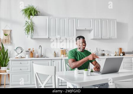 cheerful deaf african american freelancer using sign language for communication during video call Stock Photo