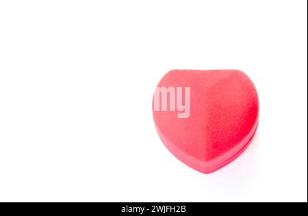 close up of red velvet ring box in heart shape arranging on white background Stock Photo