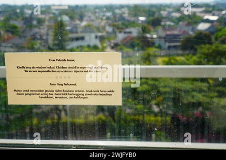 A window security alert. Kindly keep the window locked children should be supervised at all times Stock Photo