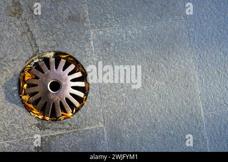 Cap drainage holes in the garden to prevent leaves from entering and clogging the hole Stock Photo