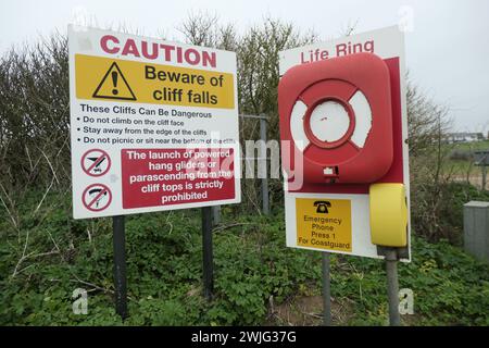 Old Hunstanton Norfolk Beware sign sign  Beach area coloured painted home house houses path passage way Caution life ring cliffs dangerous do not Stock Photo