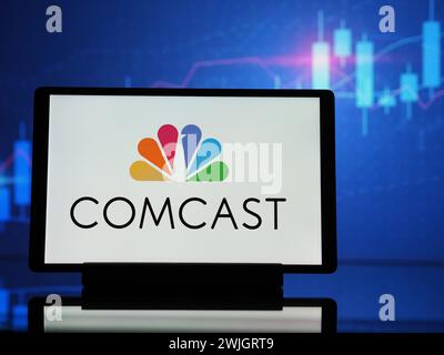 In this photo illustration a Comcast logo is seen on a smartphone ...