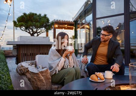 Couple engaged in friendly conversation and drinking coffee Stock Photo
