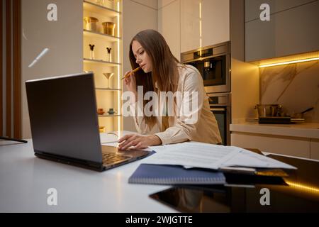 Woman using laptop working or studying from home Stock Photo