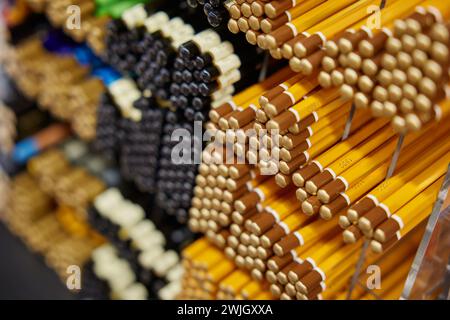Various pencils on rack display for sale in stationery shop Stock Photo