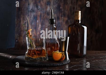 Bar counter with a drink and a bottle. Alcoholic cocktail on the bar counter. Stock Photo