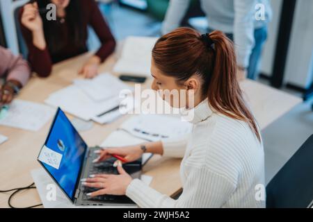 The accomplished businesswoman, along with her dedicated colleagues, collaborates on an innovative project in the bustling office. Stock Photo